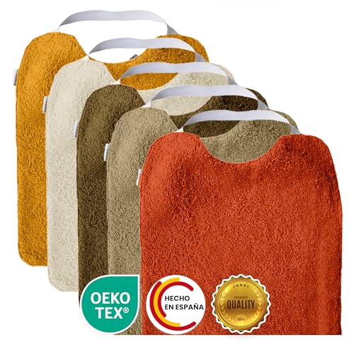 Conjunto de 5 babetes de turco com elástico, para promover a autonomia Laváveis, com interior impermeável e tecido turco de alta qualidade. Babete com gola de borracha. Fabricado em Espanha.