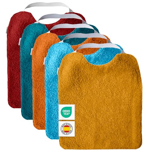 Conjunto de 5 babetes de turco com elástico, para promover a autonomia Laváveis, com interior impermeável e tecido turco de alta qualidade. Babete com gola de borracha. Fabricado em Espanha.