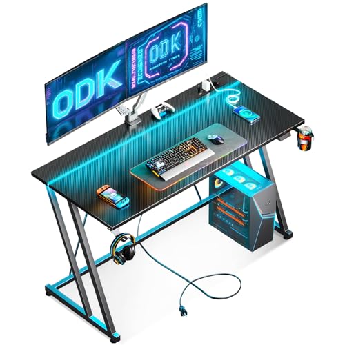 ODK 120 × 50 cm mesa de jogos com luzes LED e tomada de corrente, mesa de jogos com suporte para caneca e gancho para auriculares, design duplo Z mesa computador fibra de carbono preto