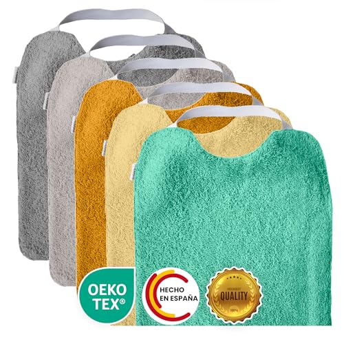 Conjunto de 5 babetes de turco com elástico, para promover a autonomia Laváveis, com interior impermeável e tecido turco de alta qualidade. Babete com gola de borracha. Fabricado em Espanha.